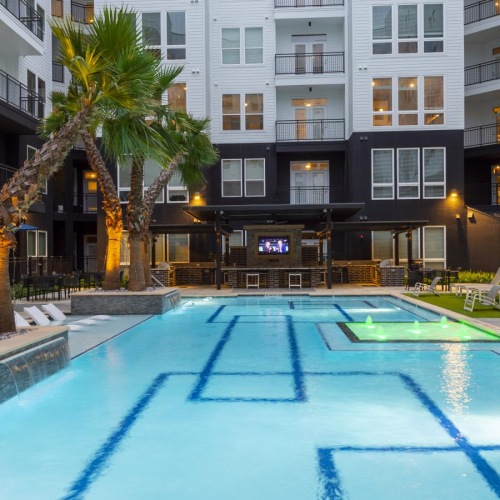 a pool in a courtyard with palm trees