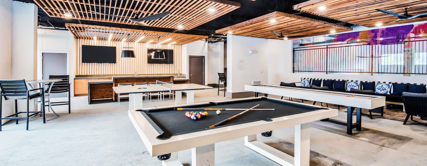 a game room with tables and chairs