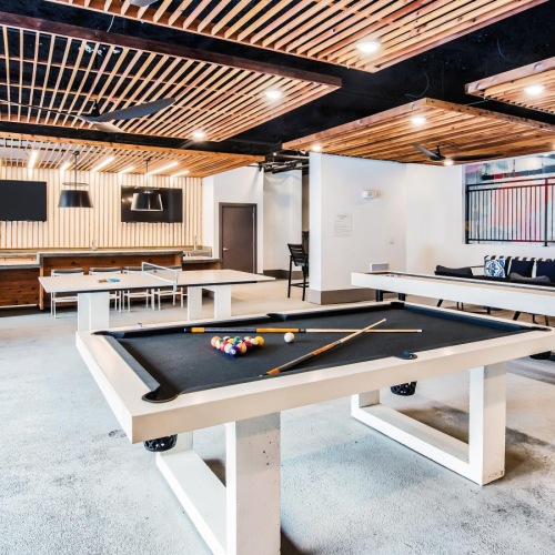a game room with tables and chairs